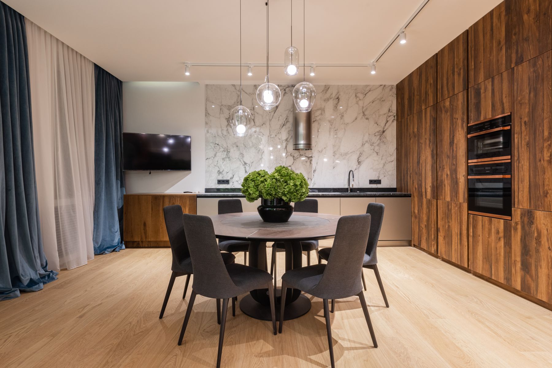 A composed dining room with wood, stone, and quiet light